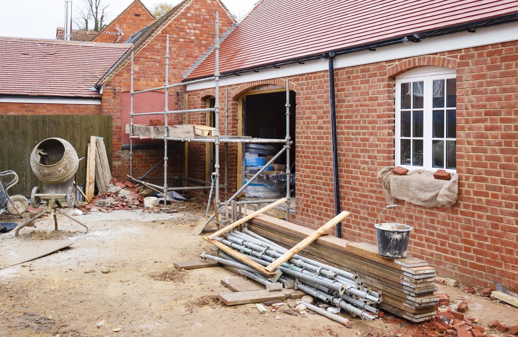 Building site in UK with brick house extension under construction